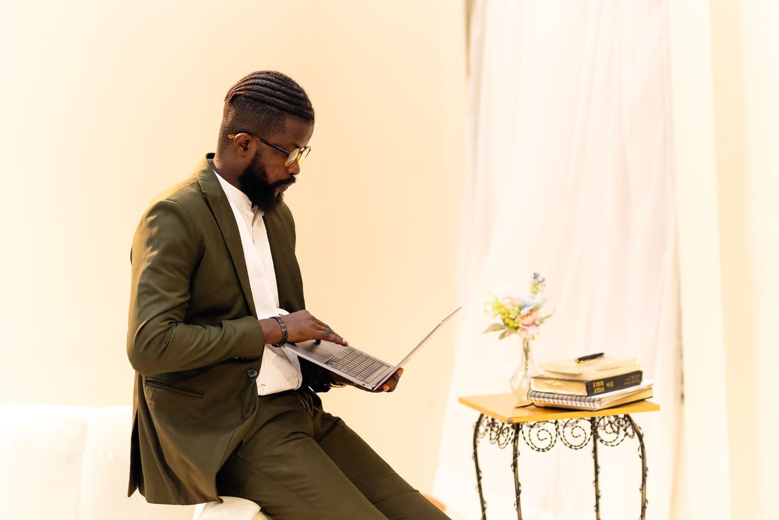 A professional working on a laptop in a bright room